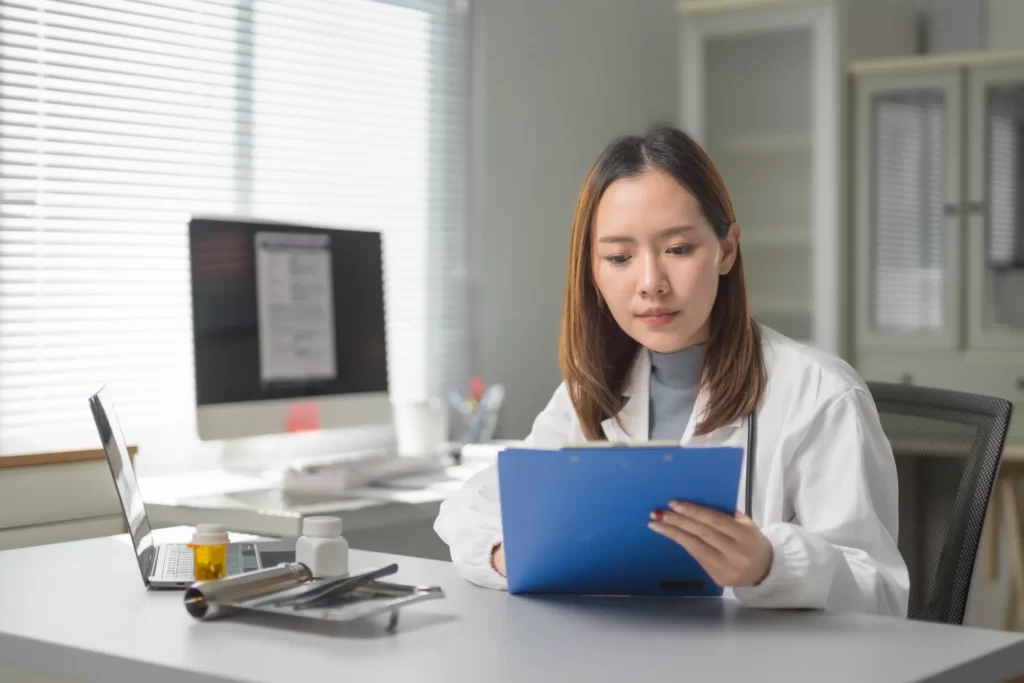 female doctor reading medical records in clinic of utc